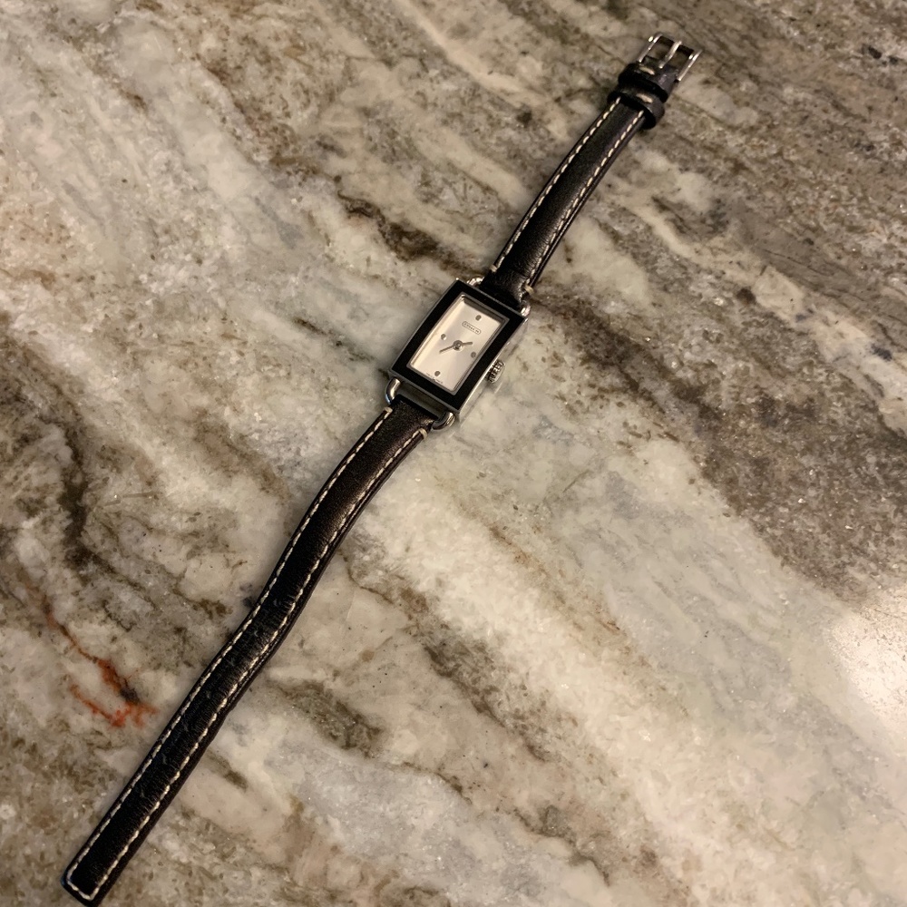 Sleek Coach Watch with slim rectangle face framed in shiny black enamel. UEC